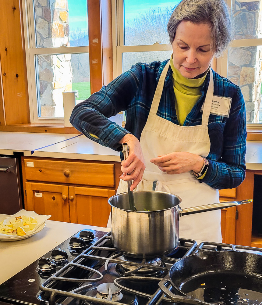 workshop student stirring pot on stove