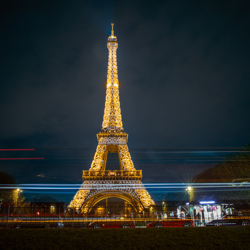 eiffel tower at night with light blur