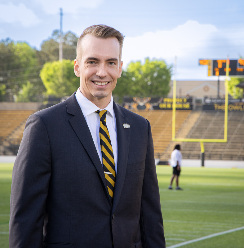 environmental portrait of a man on a football field